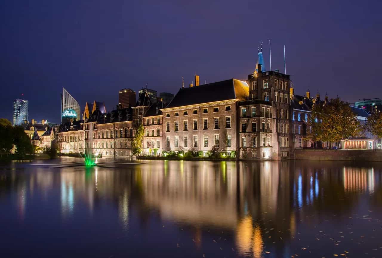 The Binnenhof lit at night and reflected in the Hofvijver pond, The Hague.